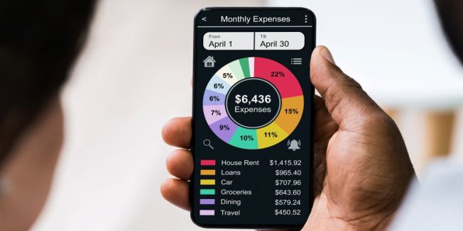 Person budgeting on a smartphone, showing how mobile apps help track spending and save money.