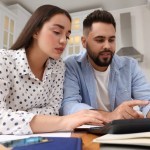 Woman and man applying online for a short-term loan to borrow quick cash from LendNation